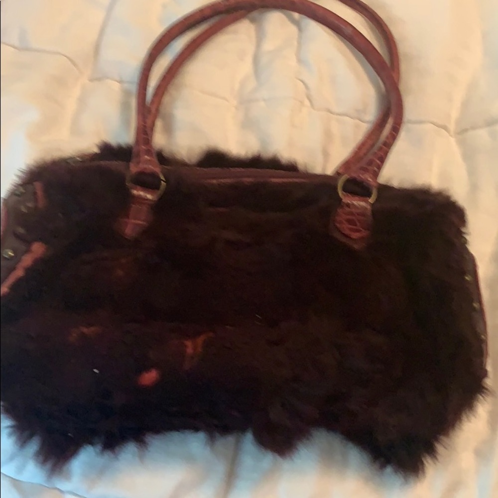 Guia’s rabbit fur handbag